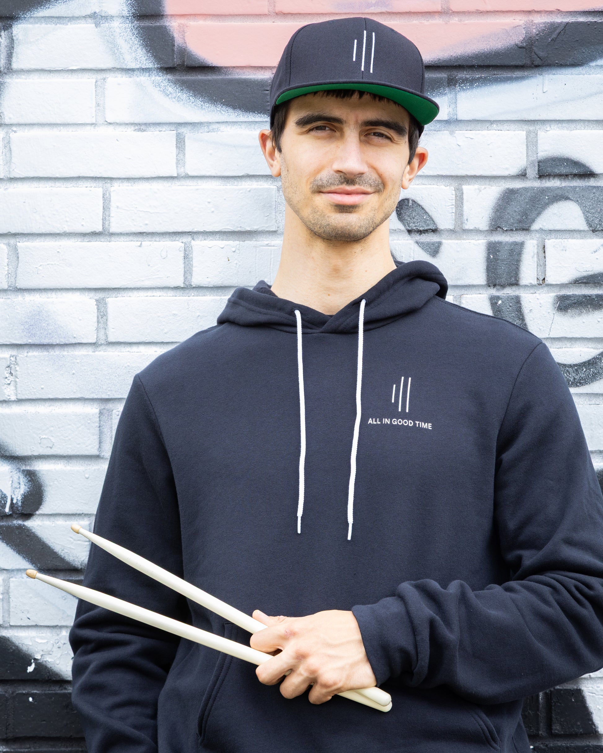 Minimalist drummer hoodie by Cowbell & Groove, black streetwear sweatshirt for drummers and musicians
